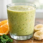 Healthy kale orange banana smoothie in a glass